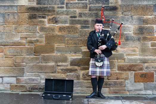 EDINBURGH, SCTOLAND - CIRCA NOVEMBER 2012: Man playing bagpipes in the street.