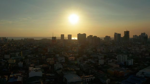 Aerial view of Panorama of Manila city with skyscrapers silhouettes. Skyscrapers and business centers in a big city. Travel vacation concept