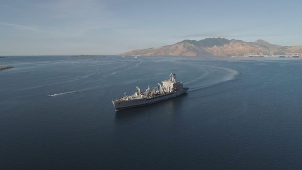 Aerial view: Cargo, Reefer ship in the sea bay. Subic Bay, Philippines, Luzon. Cargo ship in the harbor, against the backdrop of the mountains.