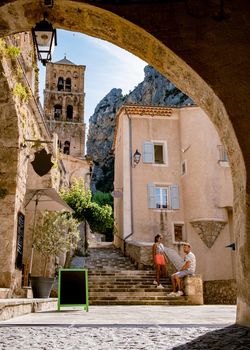 The Village of Moustiers-Sainte-Marie, Provence, France Europe, a colorful village in the Provence France, couple on vacation in France, mid age men and woman visiting Moustiers-Sainte-Marie