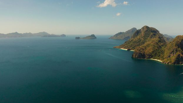 aerial view blue sea and tropical islands with beaches and mountains. Seascape with tropical rocky islands, ocean blue water. El nido, Philippines, Palawan.