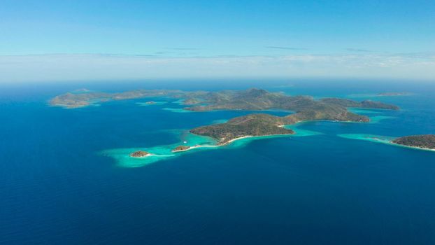 aerial seascape Lagoons with blue, azure water in middle of small islands. Palawan, Philippines. tropical islands with blue lagoons, coral reef. Islands of the Malayan archipelago with turquoise lagoons.