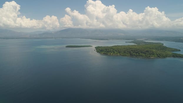 Aerial view Sea bay with islands in the background of mountains, Philippines,Luzon. Seascape with sky and clouds, ocean, mountains. Travel concept.