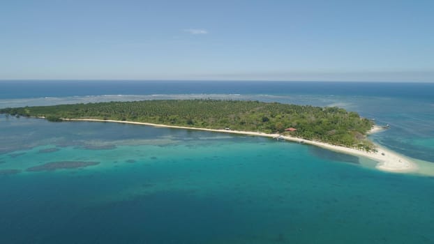 Tropical island with white sandy beach. Aerial view: Magalawa island with colorful reef. Seascape, ocean and beautiful beach paradise. Philippines,Luzon. Travel concept.