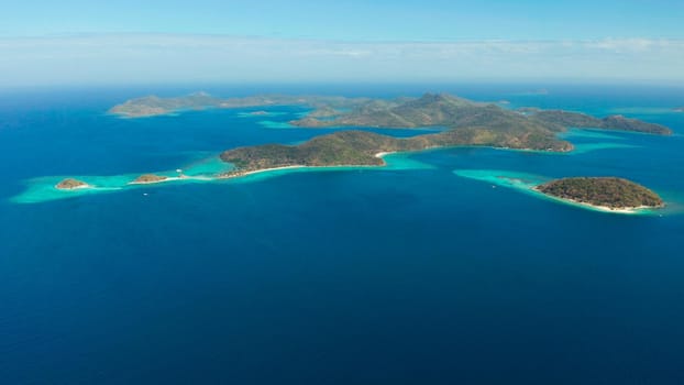 aerial seascape Lagoons with blue, azure water in middle of small islands. Palawan, Philippines. tropical islands with blue lagoons, coral reef. Islands of the Malayan archipelago with turquoise lagoons.