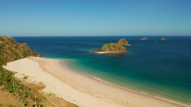 Blue sea and tropical beach, aerial drone. Nacpan, El Nido, Palawan, Philippine Islands. Seascape with tropical beach and islands. Summer and travel vacation concept