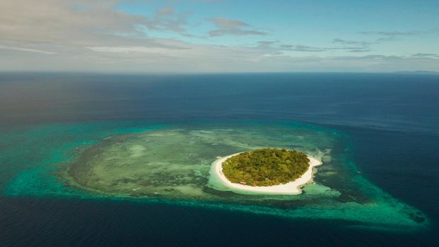 Tropical island and sandy beach surrounded by atoll and coral reef with turquoise water, aerial drone. Tropical island and coral reef. Summer and travel vacation concept, Camiguin, Philippines, Mindanao