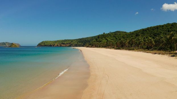 Wide sand beach Nacpan Beach, aerial view. El Nido, Palawan, Philippine Islands. Seascape with tropical beach and islands. Summer and travel vacation concept