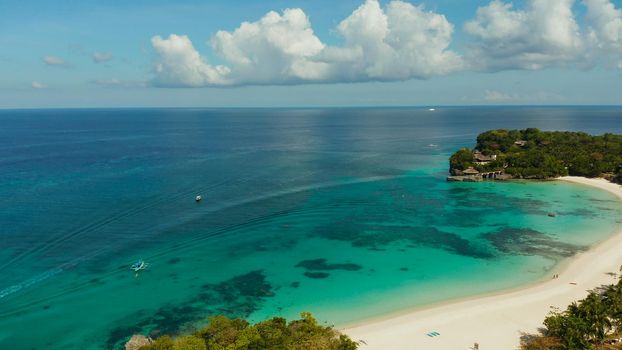 Sandy beach with blue water at tropical resort top view, Boracay, Philippines. Seascape with beach on tropical island. Summer and travel vacation concept.