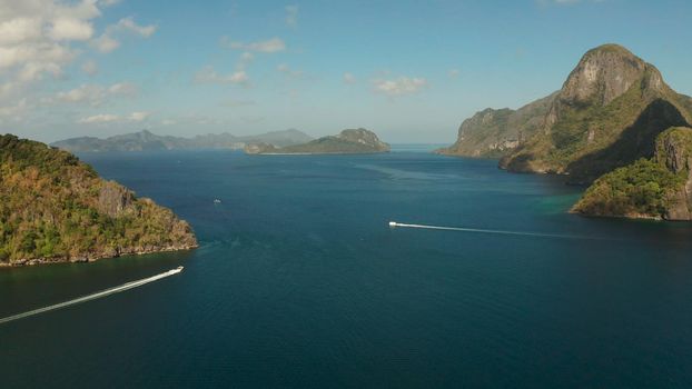 Seascape with tropical bay, rocky islands, ocean blue water, aerial view. islands and mountains covered with tropical forest. El nido, Philippines, Palawan. Tropical Mountain Range