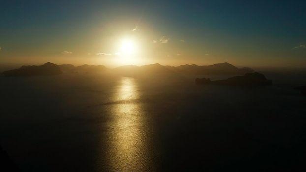 aerial view tropical bay in El Nido at sunset. Seascape with mountains and rocky islands in the morning time. Sunset sky and mountains rocks of bay. sunset over the sea