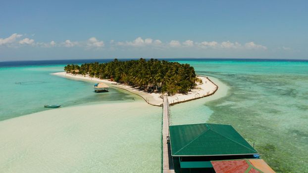 Seascape with beautiful beach and tropical island surrounded by a coral reef from above. Onok Island, Balabac, Philippines. Summer and travel vacation concept