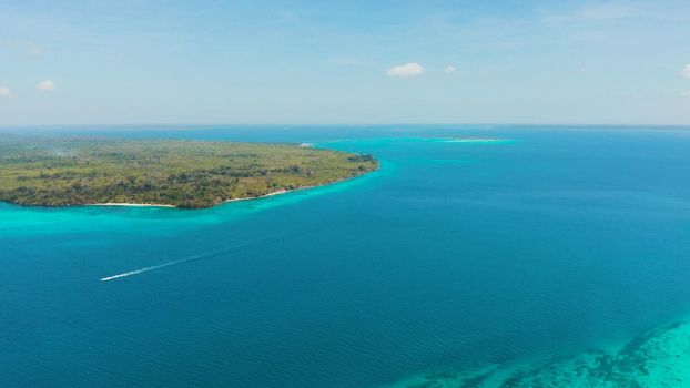 Tropical islands with coral reefs in the blue water of the sea, aerial view. Balabac, Palawan, Philippines. Summer and travel vacation concept.