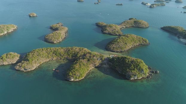 Aerial view of Small islands with beaches and lagoons in Hundred Islands National Park, Pangasinan, Philippines. Famous tourist attraction, Alaminos.