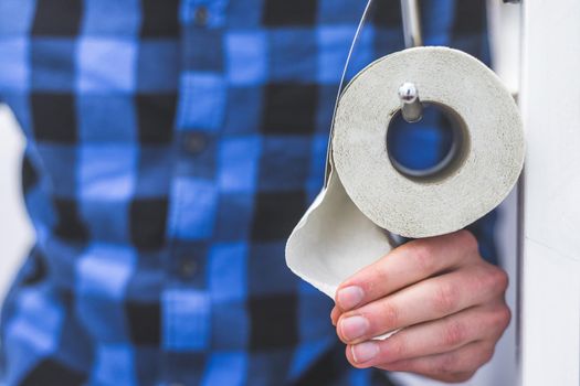 Hand of a male person using toilet paper