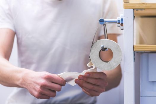 Hand of a male person using toilet paper