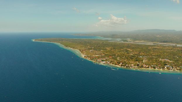 Coral reef and turquoise water with Philippine boats in the famous diving spot of Moalboal, Cebu. Aerial view, Summer and travel vacation concept