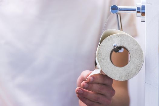 Hand of a male person using toilet paper