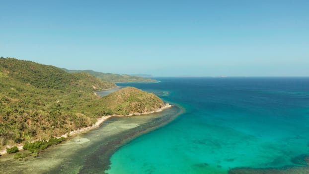 Aerial view coastline of a tropical island with coral reef and blue lagoon. Busuanga, Palawan, Philippines. tropical landscape