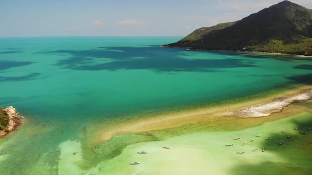 Aerial drone view island Koh Phangan Thailand. Exotic coast panoramic landscape, Chaloklum Malibu fisherman beach, summer day. Sandy path, corals. Vivid seascape, mountain coconut palms from above