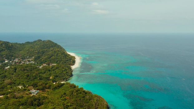 The famous tropical island of Boracay with white beach, hotels among the forest, aerial view. Summer and travel vacation concept.