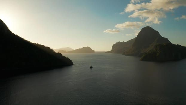 aerial view tropical bay in El Nido at sunset. Seascape with mountains and rocky islands in the morning time. sunset over the sea. Sunset sky and mountains rocks of bay. Dreamy sunset among the rocks.