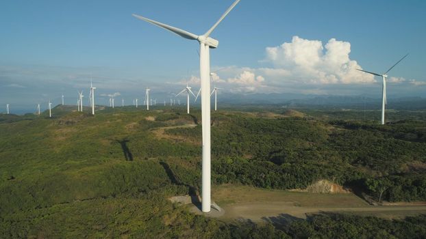 Aerial view of Windmills for electric power production on the seashore. Bangui Windmills in Ilocos Norte, Philippines. Ecological landscape: Windmills, sea, mountains. Pagudpud