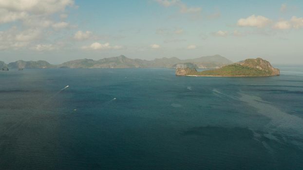 Cove with tropical rocky islands covered with rainforest, sea with blue water, aerial view. El nido, Philippines, Palawan. Tropical Mountain Range