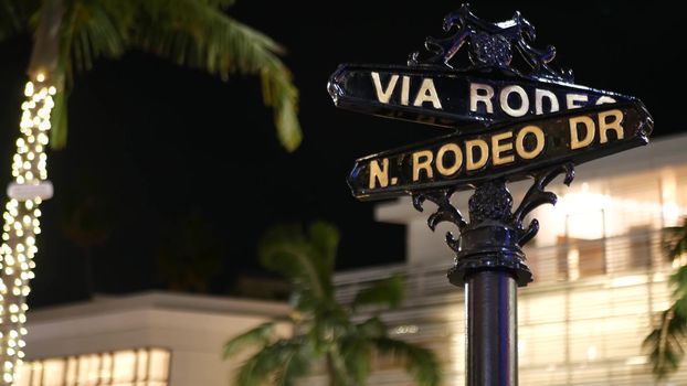 World famous Rodeo Drive symbol, Cross Street Sign, Intersection in Beverly Hills. Touristic Los Angeles, California, USA. Rich wealthy life consumerism, Luxury brands and high-class stores concept