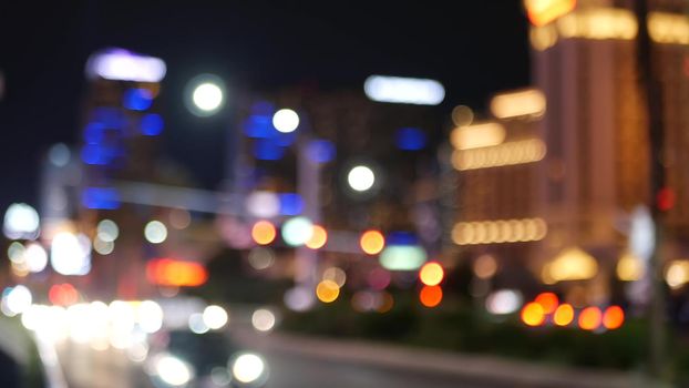 Defocused fabulous Las Vegas Strip boulevard, luxury casino and hotel, gambling area in Nevada, USA. Nightlife and traffic near Fremont street in tourist money playing resort. Neon lights of sin city.