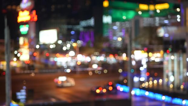 Defocused fabulous Las Vegas Strip boulevard, luxury casino and hotel, gambling area in Nevada, USA. Nightlife and traffic near Fremont street in tourist money playing resort. Neon lights of sin city.