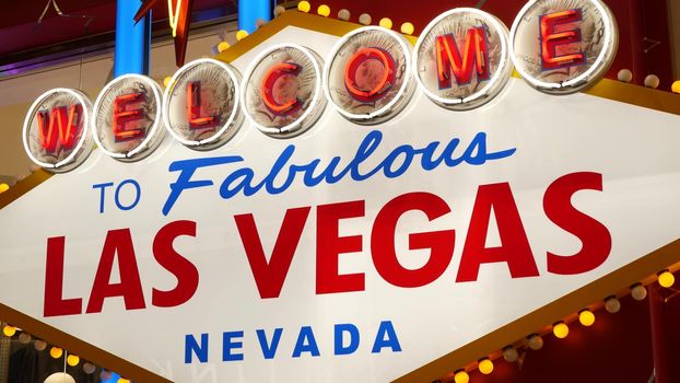 Welcome to fabulous Las Vegas retro neon sign in gambling tourist resort, USA. Iconic vintage glowing banner, symbol of casino, games of chance, money playing and hazard bets. Illuminated signboard.