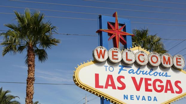 Welcome to fabulous Las Vegas retro neon sign in gambling tourist resort, USA. Iconic vintage banner as symbol of casino, games of chance, money playing and hazard betting. Lettering on signboard.