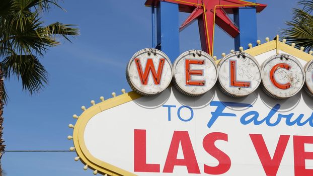 Welcome to fabulous Las Vegas retro neon sign in gambling tourist resort, USA. Iconic vintage banner as symbol of casino, games of chance, money playing and hazard betting. Lettering on signboard.