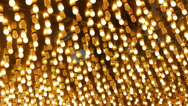 Old fasioned electric lamps blinking and glowing at night. Abstract close up of retro casino decoration shimmering in Las Vegas, USA. Illuminated vintage style bulbs glittering on Freemont street.