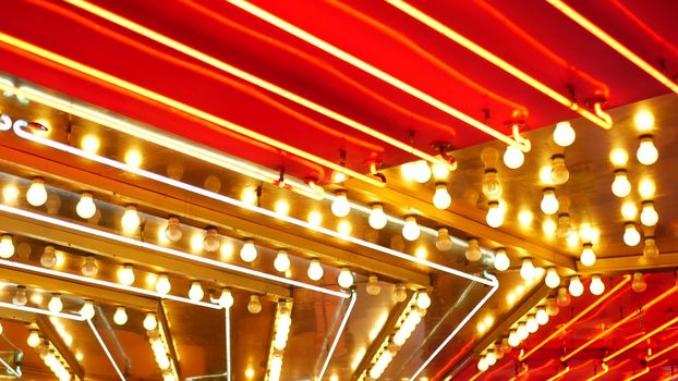 Old fasioned electric lamps blinking and glowing at night. Abstract close up of retro casino decoration shimmering in Las Vegas, USA. Illuminated vintage style bulbs glittering on Freemont street.