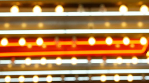 Defocused old fasioned electric lamps glowing at night. Abstract close up of blurred retro casino decoration shimmering, Las Vegas USA. Illuminated vintage style bulbs glittering on Freemont street.