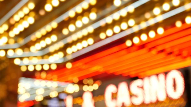 Defocused old fasioned electric lamps glowing at night. Abstract close up of blurred retro casino decoration shimmering, Las Vegas USA. Illuminated vintage style bulbs glittering on Freemont street.