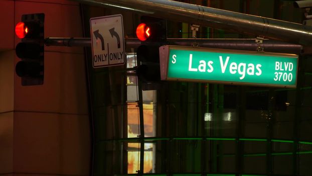 Fabulos Las Vegas, traffic sign glowing on The Strip in sin city of USA. Iconic signboard on the road to Fremont street in Nevada. Illuminated symbol of casino money playing and bets in gaming area.