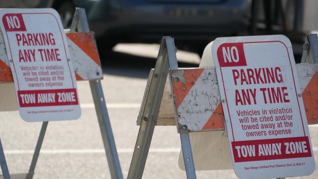 Parking lot sign as symbol of traffic difficulties and transportation issues in busy urban areas of USA. Public paid parking zone in downtown of San Diego, California. Limited space for cars in city.