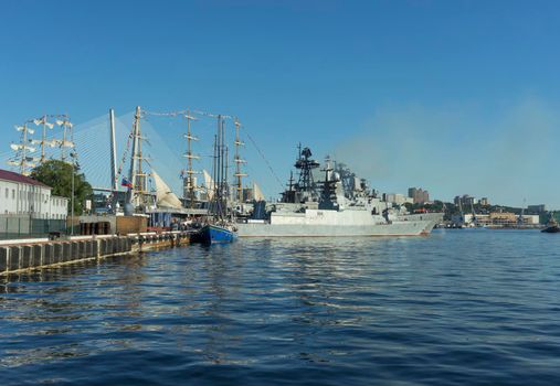 Vladivostok, Russia. Warships and sailboats in the port of the city.