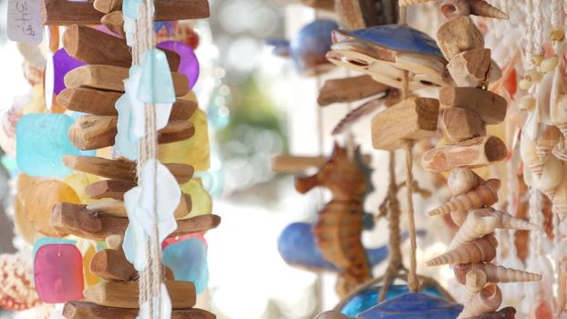 Nautical style hanging seashells decoration, beachfront blue wooden holiday home, pacific coast, California USA. Marine pastel interior decor of beach house in breeze. Summertime sea wind aesthetic.