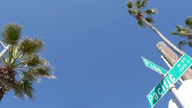 Pacific street road sign on crossroad, route 101 tourist destination, California, USA. Lettering on intersection signpost, symbol of summertime travel and vacations.Signboard in city near Los Angeles.