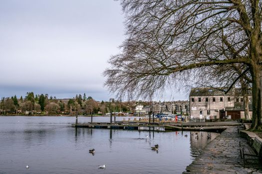Bowness on Windermere, Cumbria, UK - February 01, 2021: Tourist pleasure boats on Bowness Bay Lake Windermere during covid lockdown