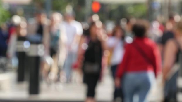 Defocused crowd of people, road intersection crosswalk on The Strip of Las Vegas, USA. Anonymous blurred pedestrians on walkway in crowded urban downtown. Unrecognizable american citizens in sin city.