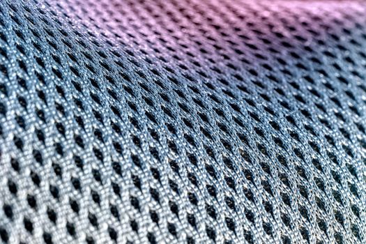 Macro shot of a mesh-like undulating gray-silvery purple surface