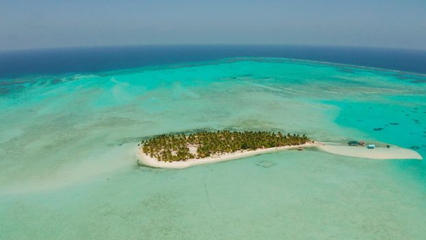 Travel concept: sandy beach on a tropical island by coral reef atoll from above. Onok Island, Balabac, Philippines. Summer and travel vacation concept