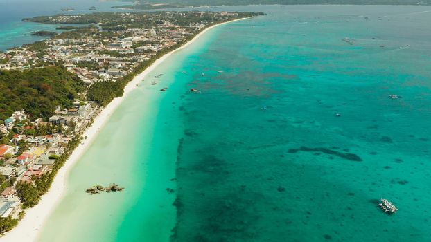 Aerial view of beautiful bay in tropical Island with white sand beach Boracay, Philippines. White beach with tourists and hotels. Tropical white beach with sailing boat.