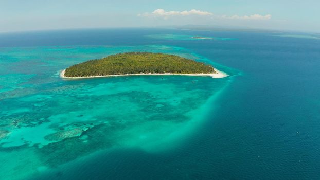Tropical island with sandy beach by atoll with coral reef and blue sea, aerial view. Patongong Island with sandy beach. Summer and travel vacation concept.