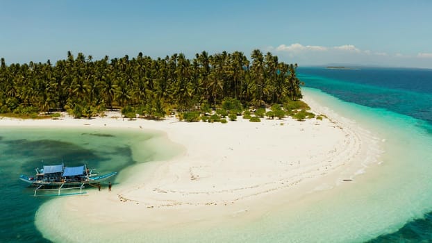 Tropical landscape: small island with beautiful beach, palm trees by turquoise water view from above. Patongong Island with sandy beach. Summer and travel vacation concept.